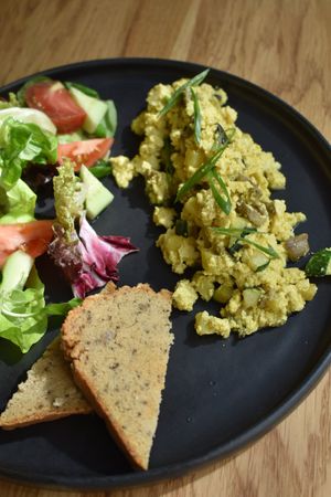 Tofu scramble with saide salad and glute-free lentil bread at Steppe Healthy and Vegan Bakery, in Lviv