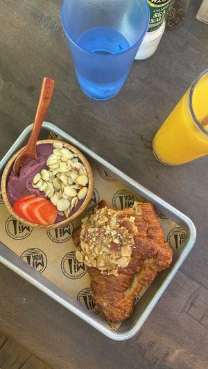 Child smoothie bowl, fresh orange juice, almond criossant   at Mi Vida in Tybee Island