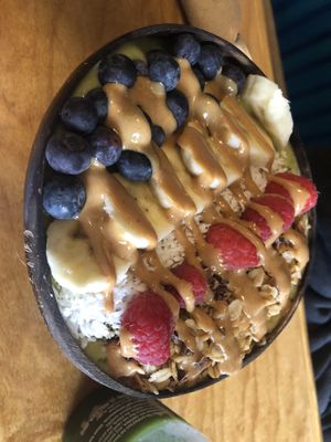 Smoothies bowls : tropical green (spinach, mango, pineapple, banana ) then fresh berries, banana slices, coconut flakes, cacao nibs , hemp hearts & peanut butter drizzle   at Lightbox Cafe in Philadelphia