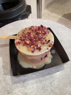 Apple crumbs with hot custard and rose petals on the top  at Humble Crumble in South East London