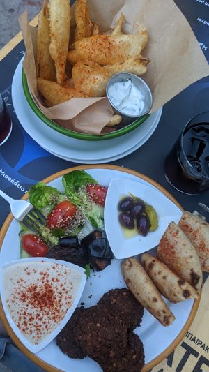 Falafel plate and zucchini fries in background at EATERY in Athens