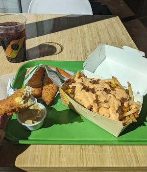 Chicken tenders with honey mustard sauce, iconic fries... blueberry soda at Plant Power Fast Food - Craig Rd in Las Vegas