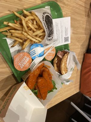 Chicken & waffle sandwich with fries and buffalo wings.  at Plant Power Fast Food - Craig Rd in Las Vegas
