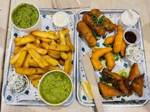 Assortment of tofish bites, lemon prawns, battered sausages, chips & mushy peas  at The No Catch Co in Brighton