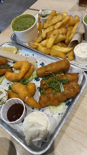 Chips, peas, vegan cod, vegan lemon shrimp, and sausages  at The No Catch Co in Brighton