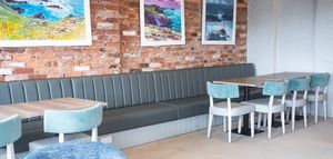 Separate dining areas with a cosy feel and paintings by local artists at The Bowgie Inn in Newquay