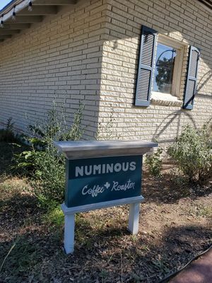 Outside sign at Numinous Coffee Roasters in Marble Falls