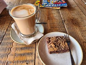 Oatmilk latte and chocolate tiffin at ComiCoffee in Newport