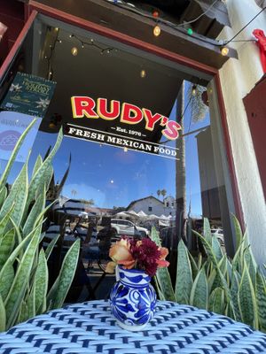 Outside seating, with colorful flowers everywhere   at Rudy's in Santa Barbara