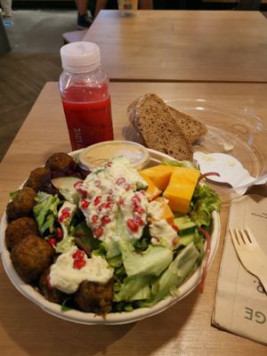 The falafel tahini bowl with bread on the side included at MUC - Dean & David - T2 in Munich