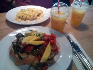 Fresh orange juice, scambled eggs on toast, vegan grilled veg on sourdough at Avocado and Coffee in South East London