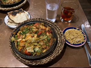Cabbage with potato, peas, and carrots tagine with pita and rice. Also pictured is the Marakesh Sunset (May contain honey, not sure) alcoholic beverage which is strong and deli    at Tara Kitchen in Albany