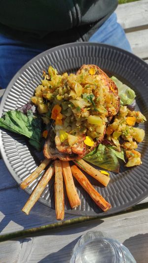 Roasted bread with vegan cheese and 'salad' of green tomatoes on top. at Sono Matseljur in Reykjavik