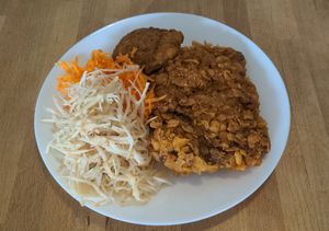 Tofu skin steak alongside cabbage and carrot salads at Vega in Warsaw