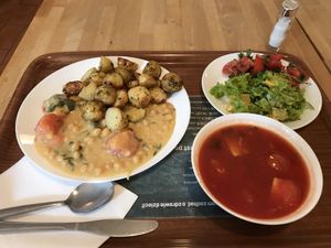 Tomato soup, “goulash”, baked new potatoes, 2 types of salad: lettuce+orange+sesame seeds and tomato+rucola+sunflower seeds.  at Vega in Warsaw