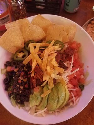Salad included greens, black beans, tomatoes, avocado, jalapenos, olives, and tortilla strips at Geddy's in Bar Harbor