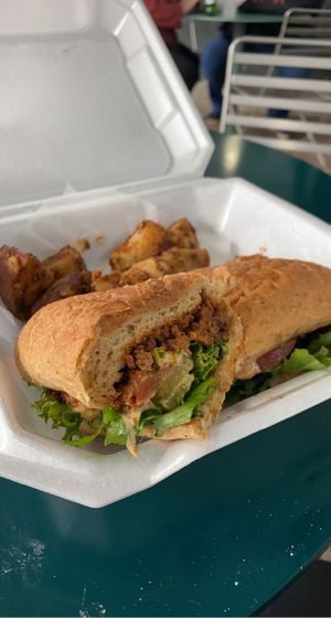 Chef Kell’s Hot Sausage Po Boy (Vegan) with Grilled Potatoes.  at Meals From The Heart Cafe in New Orleans