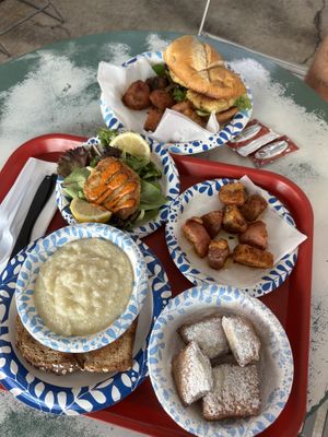 Single (amazing) vegan krab cake, absolutely delish vegan cheezy grits, vegan beignets, vegan krab po boy, potatoes came with    at Meals From The Heart Cafe in New Orleans