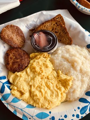 Grits eggs and chicken sausage plate, comes with fruit cup and toast  at Meals From The Heart Cafe in New Orleans