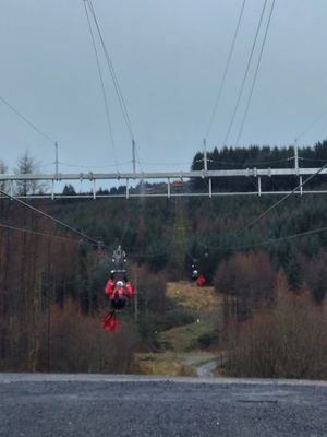 Views of people coming down Phoenix zip line at Cegin Glo in Aberdare
