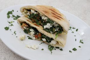 Spinach, Feta Cheese & tomatoes, baked in a pita bread ~ served with garlic sauce. at Habibi Kush in Miami