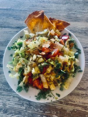 Fattoush Salad - Fresh and bright salad made with seasonal vegetables and topped with our iconic pita chips at Habibi Kush in Miami