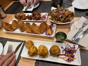 Onion fritters, okra crunch, vegetable samosas, and alu vada at House of Naan in New Haven