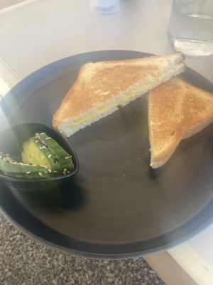 Cheese toastie with some cucumber with seeds sprinkled on ( I filled this with my scramble tofu mix)   at Come Back in Naoussa