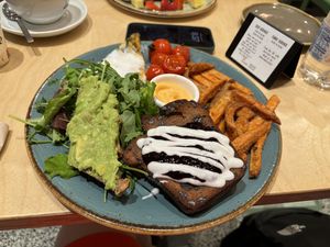 Brunch plate: omelet, choc chip banana bread, sweet potato fries, avocado toast, salad  at Shake Cafe - Via dei Neri  in Florence