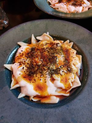 Manti filled with potato, with rapeseed oil, tomato sauce, and soy yoghurt at myMANTI in Ludwigshafen