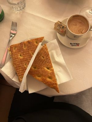 Focaccia sandwich with chickpea cream and spinach. Espresso with non-dairy milkk  at Bar Il Palio in Siena