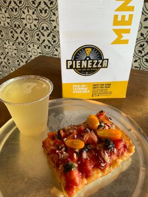 Vegan Bruschetta slice and kombucha l. at Pienezza Pizza in Kissimmee