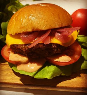 1/4lb cheeseburger with lettuce tomatoes homemade burger sauce pickled red onions  at Greedy Vegan in Chelmsford