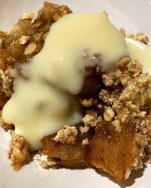 Homemade spicy Apple crumble with custard  at Greedy Vegan in Chelmsford