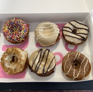 (Clockwise starting from top left) Homer, Maple Chai, Samoa, Churro, Peanut Butter Cup, and Peach Cobbler.  at Dude's Donuts in Port Orchard
