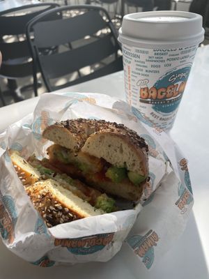 Toasted everything bagel with avocado, tomato, and hash browns. Oat milk latte  at Siegel's Bagelmania in Las Vegas
