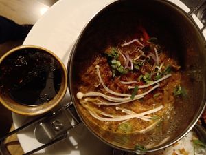 From the rendang dabba menu: 'Rendang of pointed cabbage with enoki mushrooms' with a pot of 'Ketjapsambal' at Dabba Dinner in Nijmegen