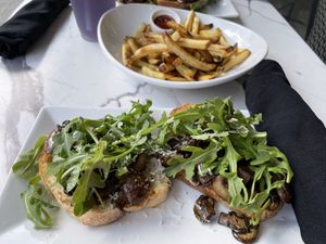 Mushroom arugula toast with truffle fries   at Coco Bistro & Bar in Chapel Hill