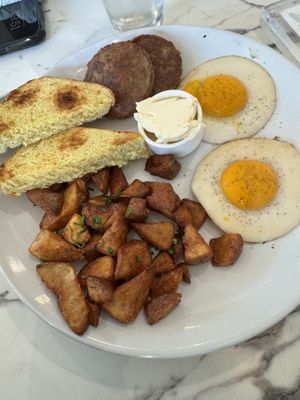 Over easy eggs, Beyond sausage, and homefries.   at Coco Bistro & Bar in Chapel Hill