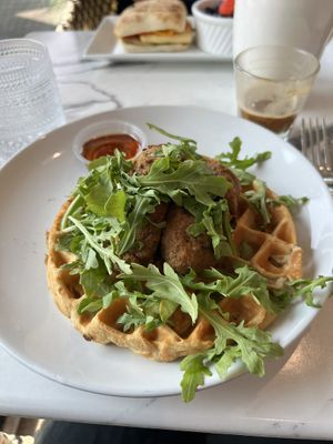 Vegan chicken (seitan) and waffles.  SO GOOD!  Vegan grilled cheese breakfast sandwich in the background.  at Coco Bistro & Bar in Chapel Hill