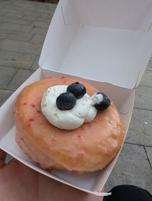 donut with raspberry frosting, whipped cream & blueberries at Bungnuts vegan Doughnuts. in Barcelona