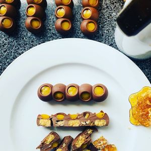 Mylk Chocolate Bubble Log, Coconut & Date Cream, Walnut Praline, Mandarin Gel at Happily Ever Vegan in Corio