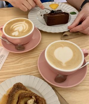 Cappuccino, cinnamon roll, and chocolate cake at Sakura in Berlin
