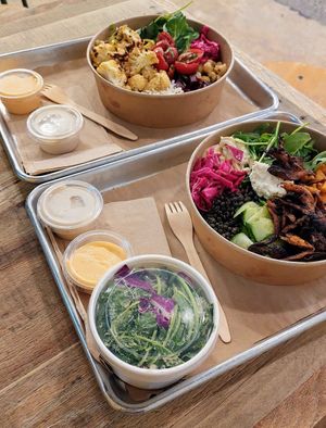 Mushroom schwarma bowl & cauliflower bowl w/ side of kale salad, plenty of sauce! at Shouk in Rockville
