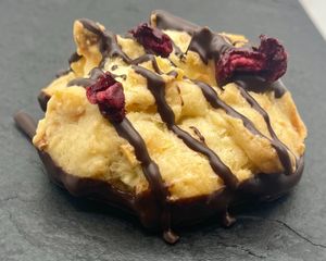 Vegan Cherry Macaroon : Moist Shredded Coconut Macaroon dipped in Dark Chocolate, topped with Cherry Pieces  at Notea in North London