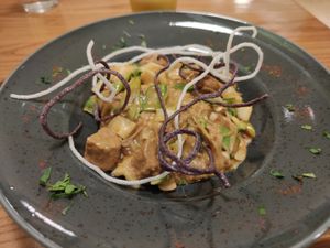 Rice noodles with glazed home-made tempeh, various fresh vegetables, coriander and other herbs, crispy noodles, in a creamy soy sauce. It was excellent.  at Avocado in Athens