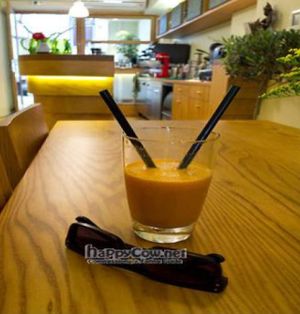 Tasty carrot cucumber juice on our table! Mmm! A view of the juice bar in the back and the door that faces Nikis St.   at Avocado in Athens