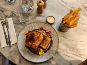 Crème brûlée brioche french toast with raspberry compote and vanilla cream. Also, lemon pepper fries. at Mallow - Borough Market in South East London