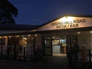 The front area, with picnic style tables around the corner and hanging lights which create a lovely atmosphere.  at Round Hill Road in Agnes Water