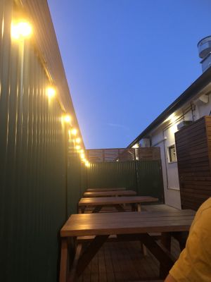 Towards the back area of the restaurant. Hanging lights and picnic tables create a lovely, relaxed atmosphere.  at Round Hill Road in Agnes Water